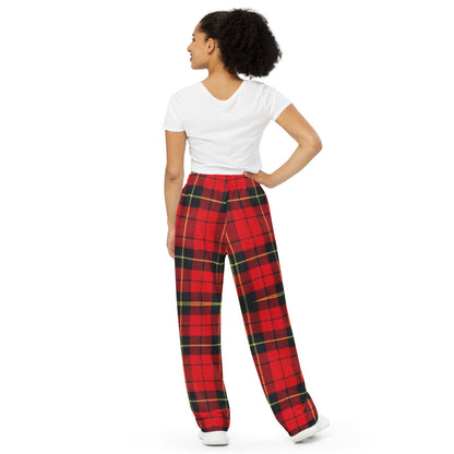 Back view of woman with one hand on waist wearing tartan print comfort pants