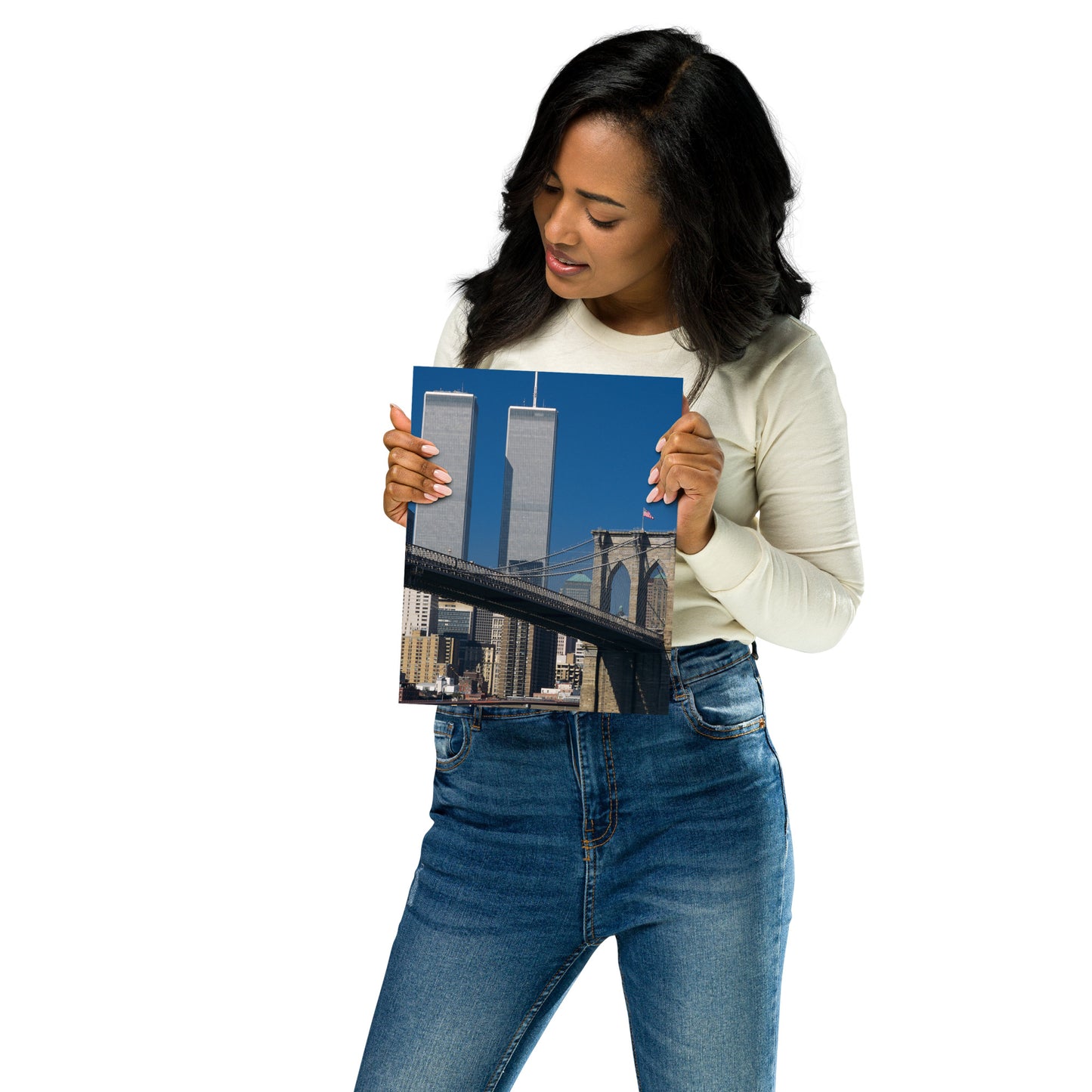 Woman holding an 8" x 10" poster of the World Trade Center Twin Towers and Brooklyn Bridge