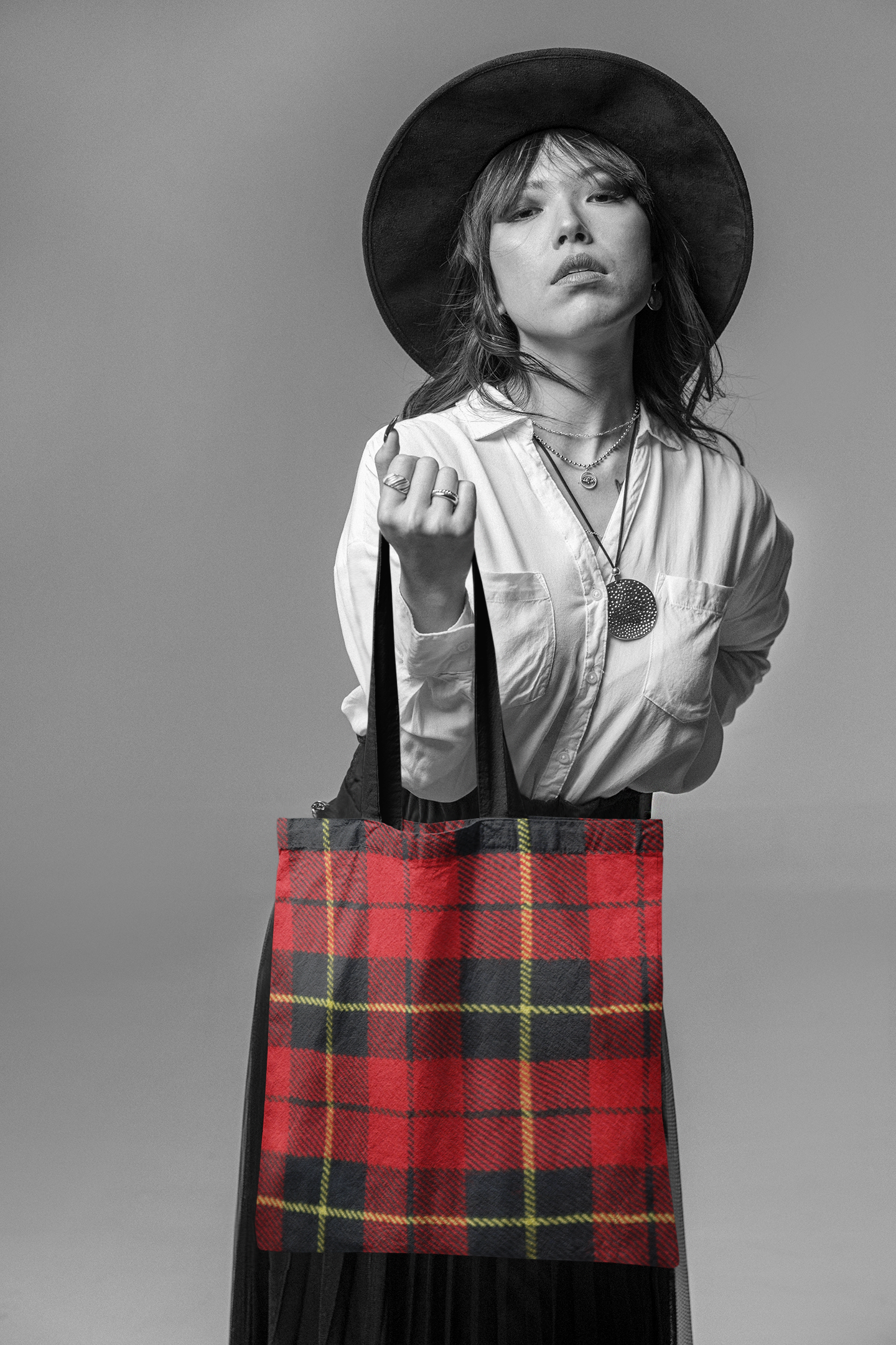 woman holding a tartan plaid tote bag