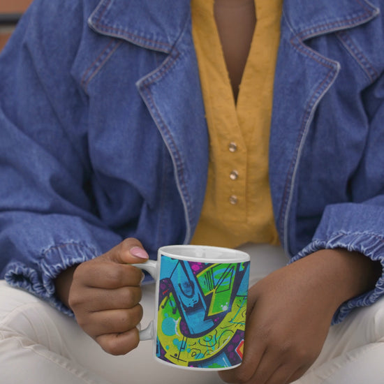 Video of woman holding a bright neon blue graffiti art coffee mug