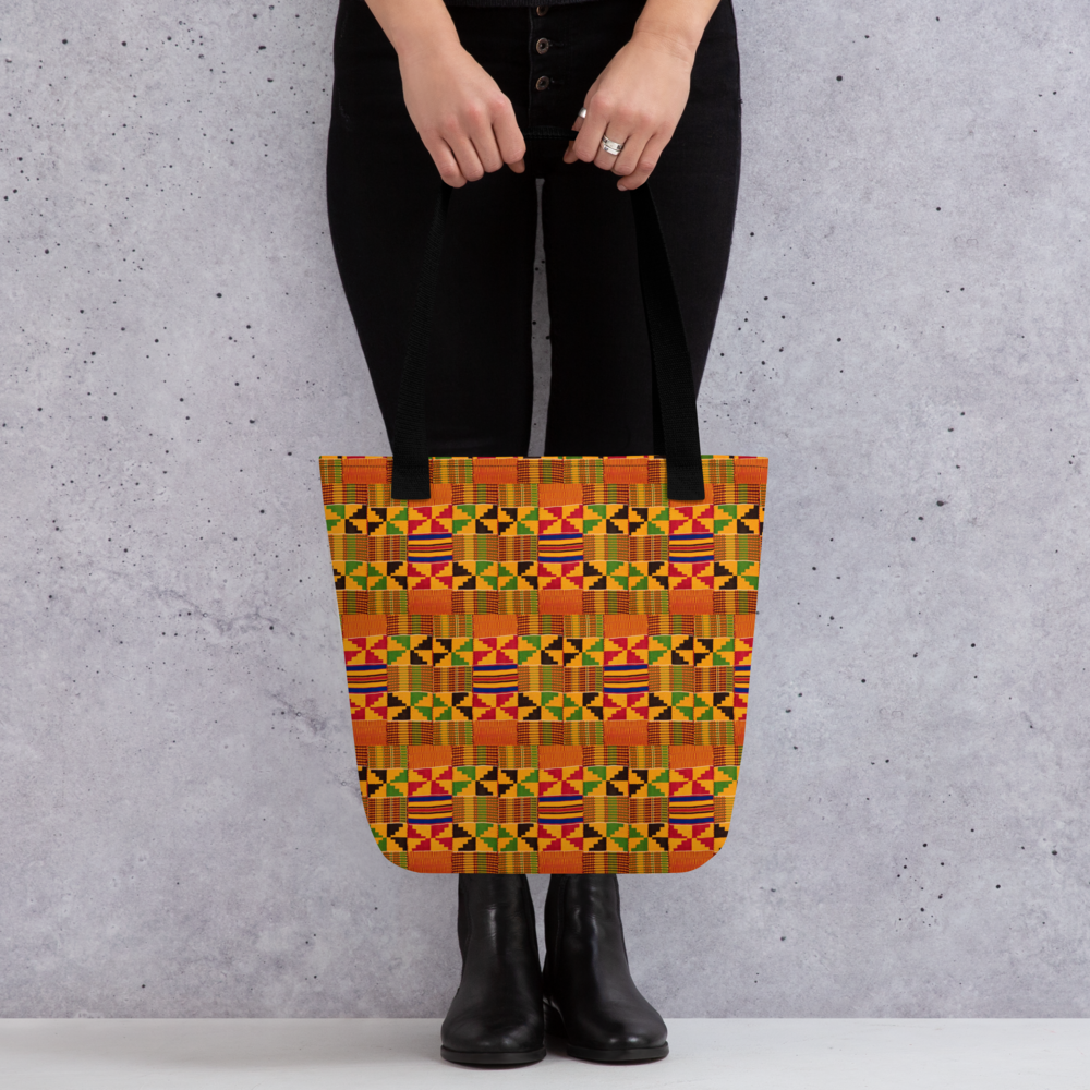 Woman holding a Kente cloth tote bag