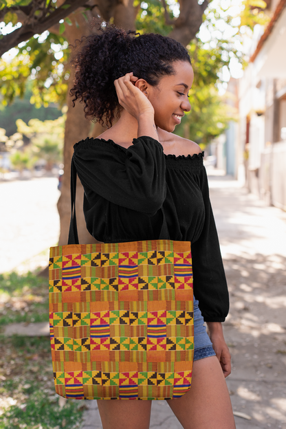 Woman wearing a back off the shoulder long sleeve blouse and denim shorts with a Kente cloth tote bag over her shoulders